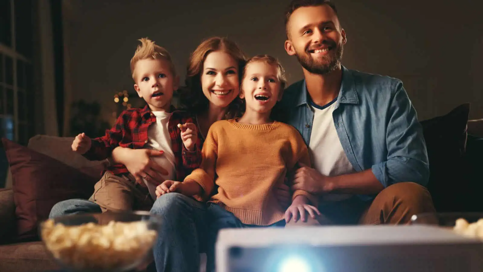 Family watching a movie with projector