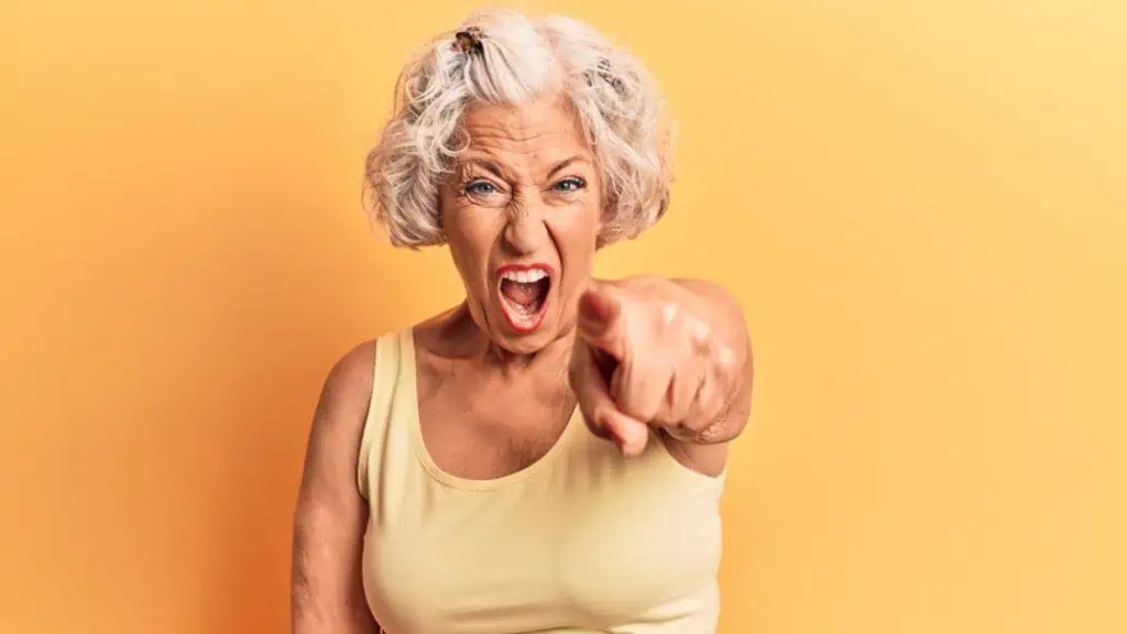 Frustrated old woman wearing casual clothes pointing finger