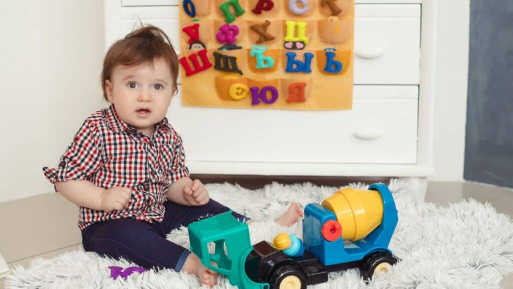 Funny baby toddler boy playing at home