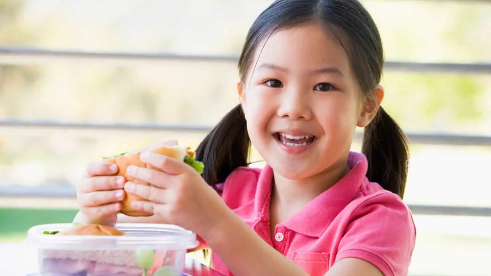 Girl eating lunch at kindergarten