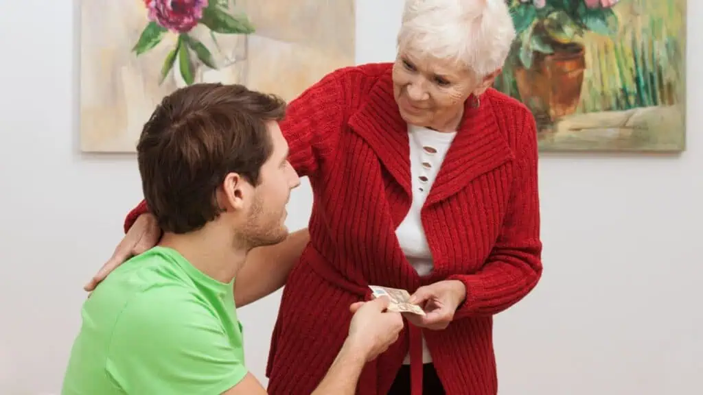 Grandmother giving her son a money
