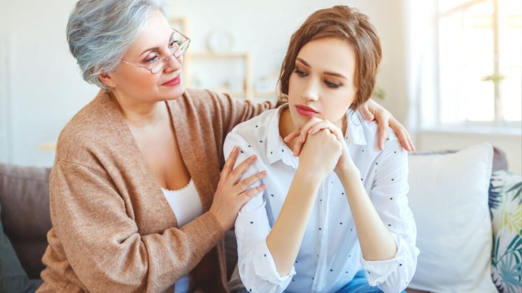 Grandmother trying to comfort her grand daughter at home
