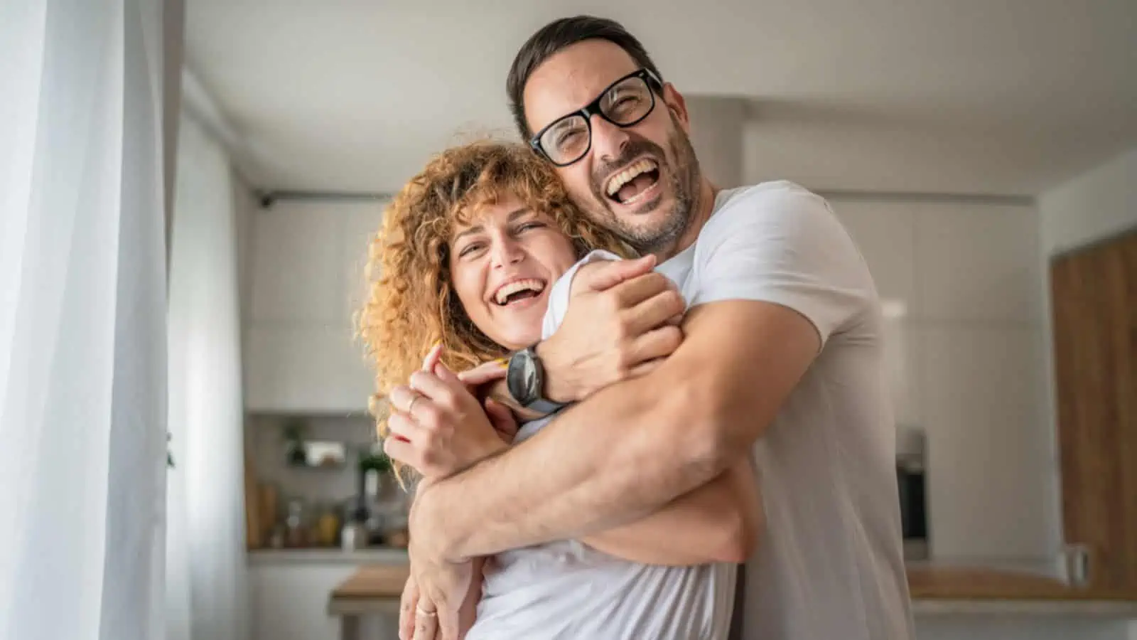 Happy caucasian adult couple man and woman at home together smile