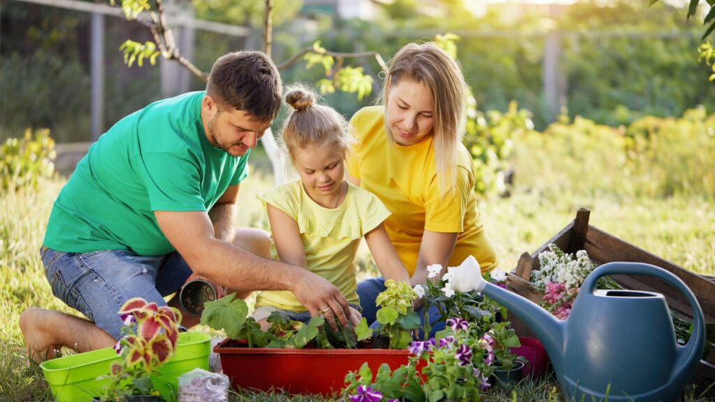Happy family gardening together and taking care of nature