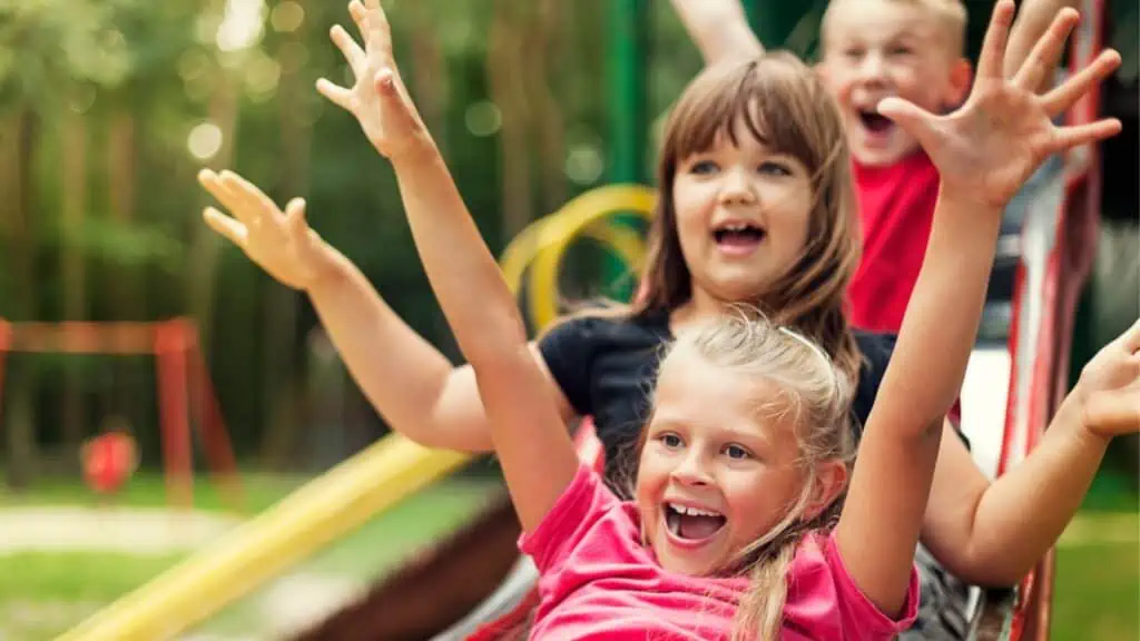 Happy kids playing on slide