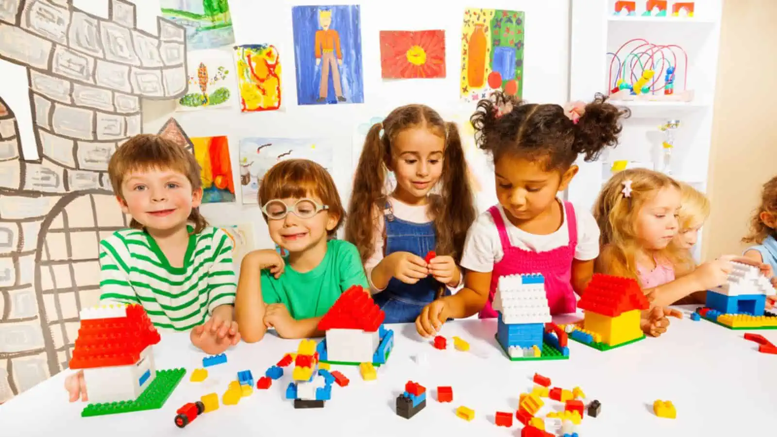 Happy kids playing toys and colorful blocks