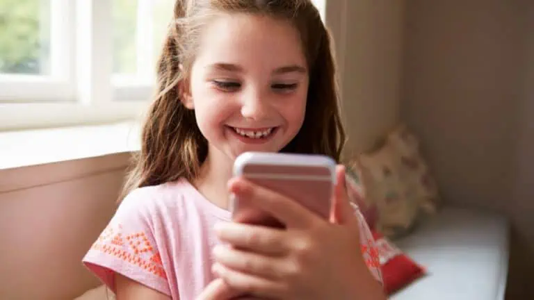 Happy little girl Playing Game On Phone
