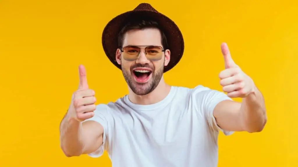 Happy man thumbs up on yellow