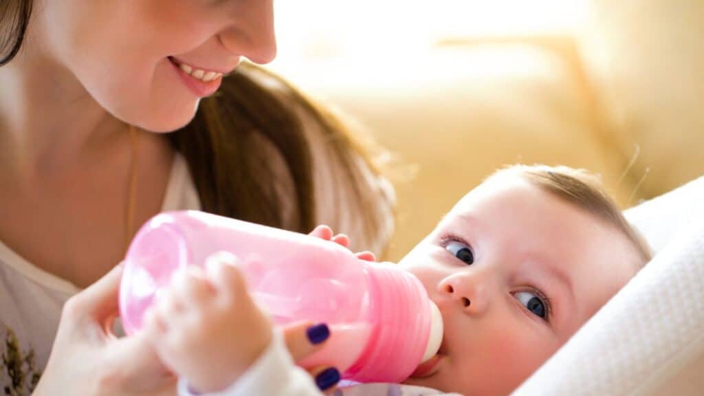 Happy mother feeding baby
