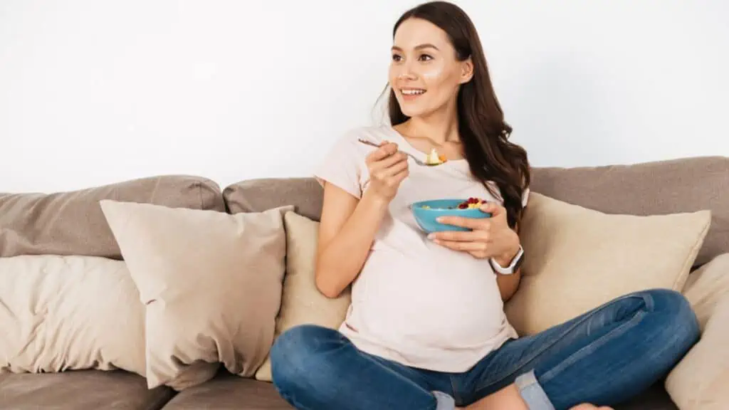 Happy pregnant eating healthy food
