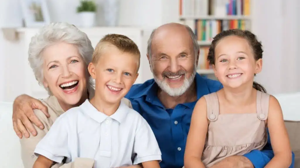 Happy young siblings with their grandparents