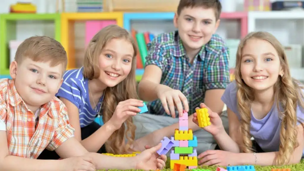 Kids playing lego with green carpet