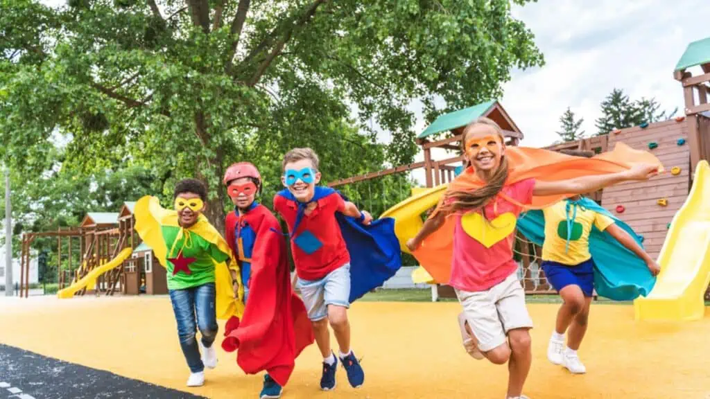 Kids wearing superhero costumes and having fun outdoors