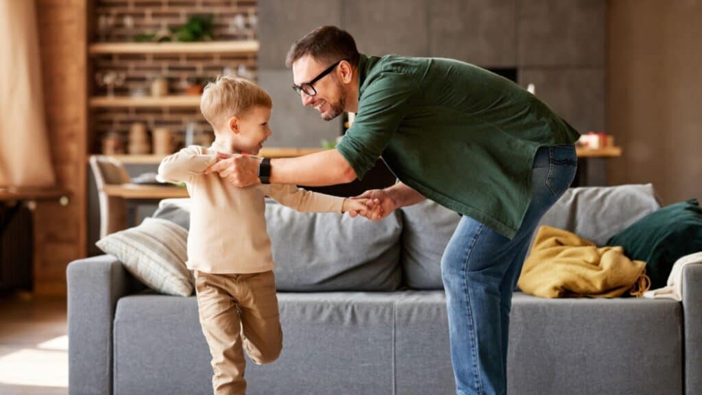 Laughing dad and son at home