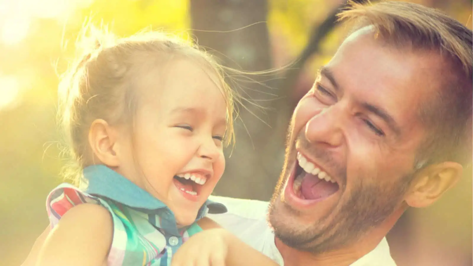 Laughing dad with his little daughter