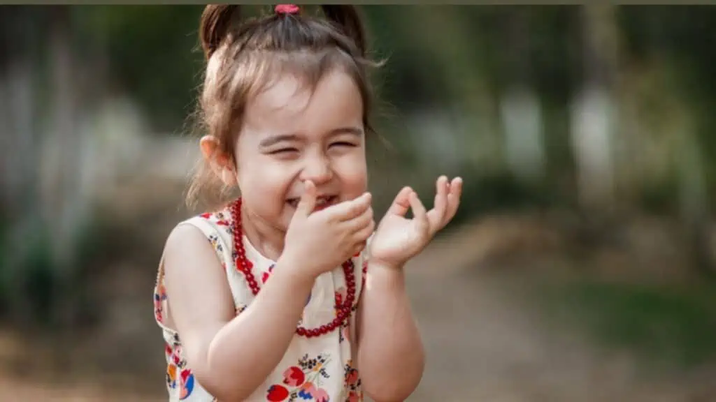 Laughing little girl wearing a vintage dress