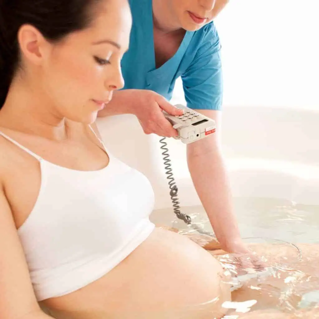 pregnant woman in labor having a water birth