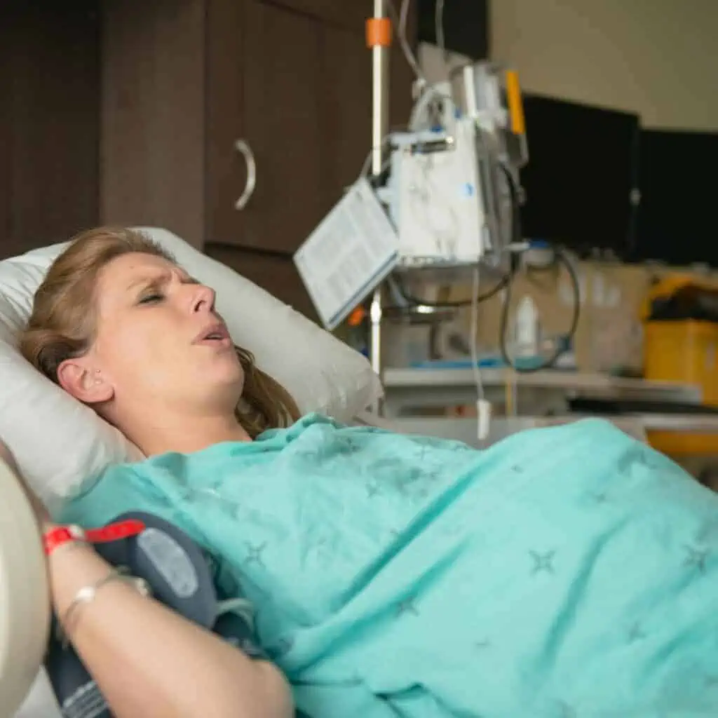 woman in labor lying on her bed