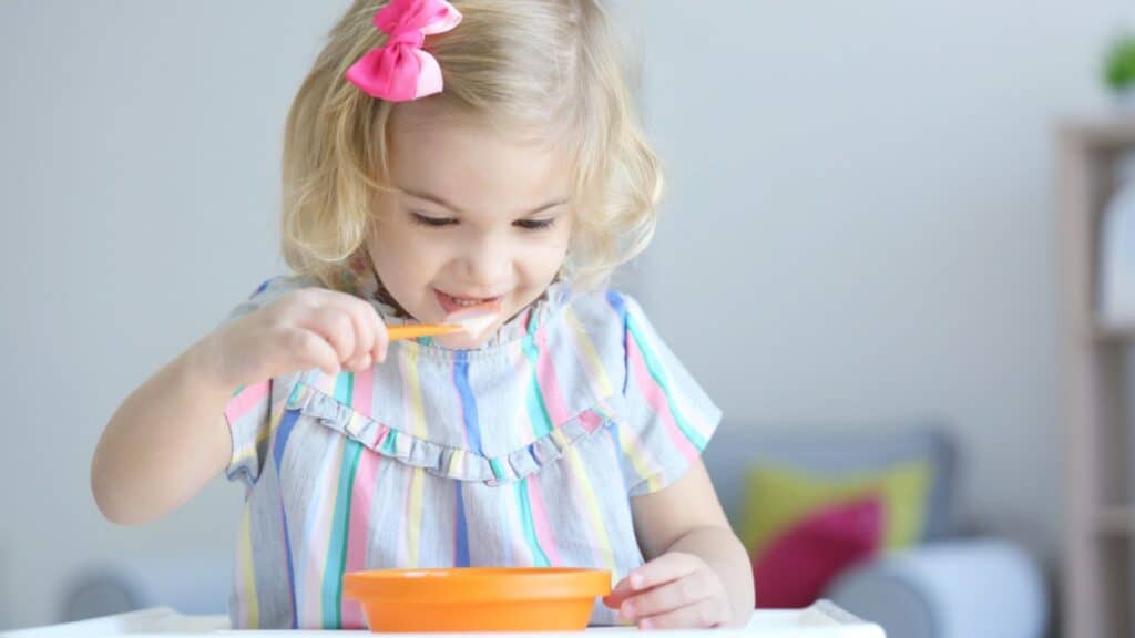 Little girl eating yogurt