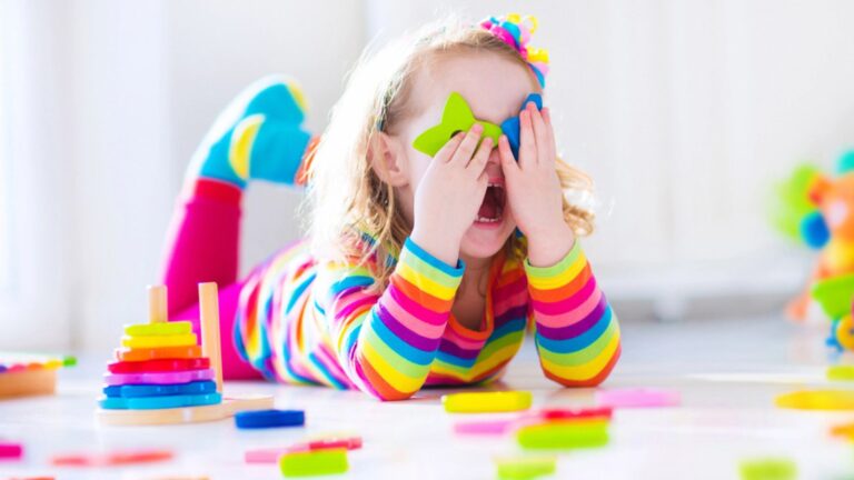 Little girl playing with wooden toys