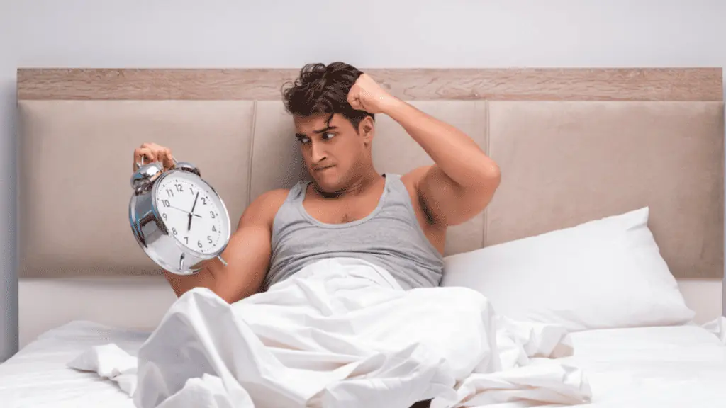 Man having trouble waking up in the morning