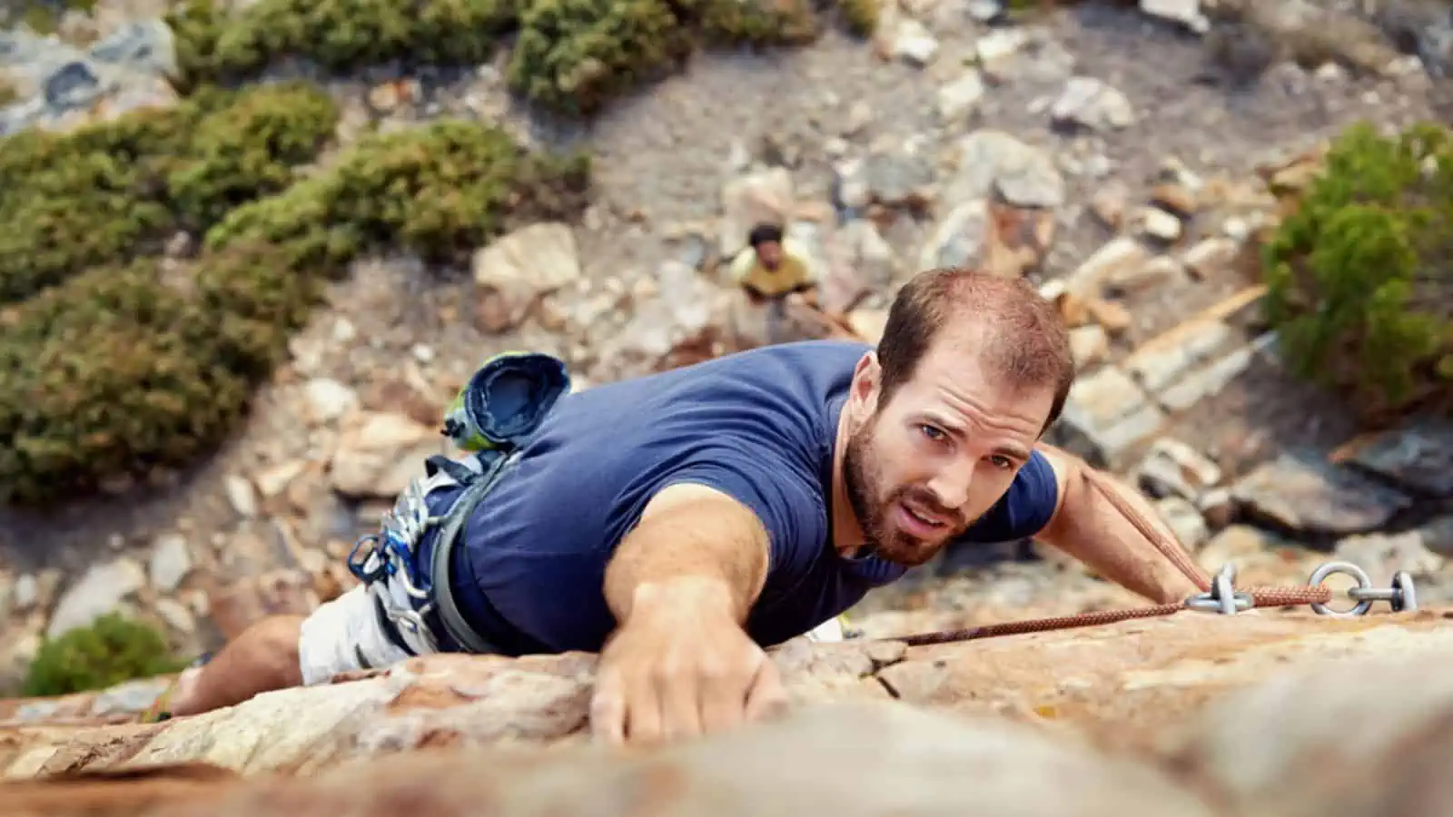 Man rock climbs on steep cliff