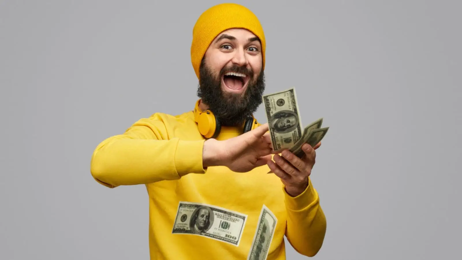 Man wasting money wearing yellow isolated in gray