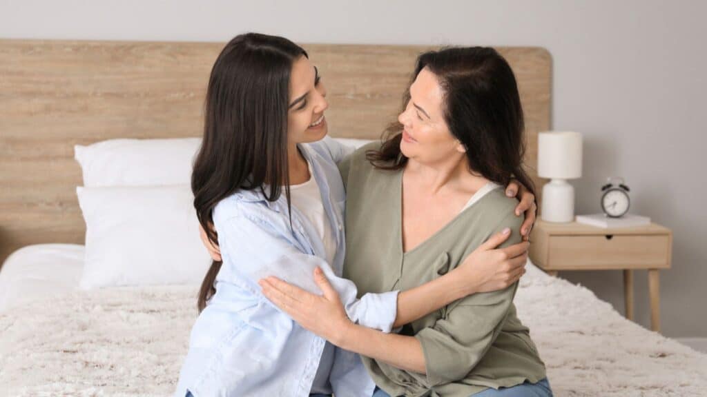 Mature woman and her adult daughter spend time together at home