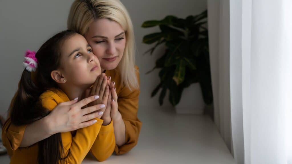 Mom and daughter praying