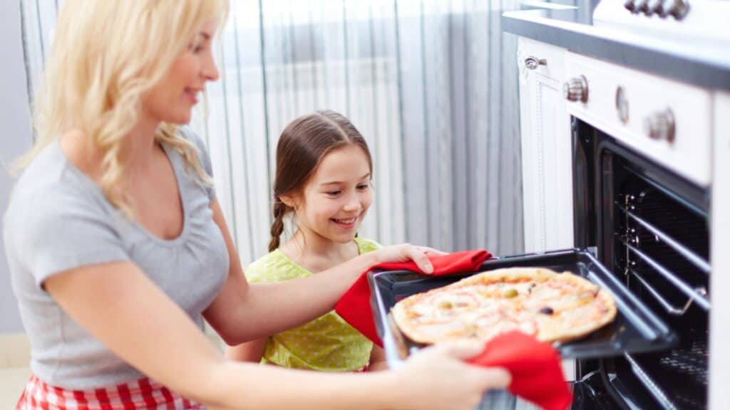Mother and daughter baked a pizza