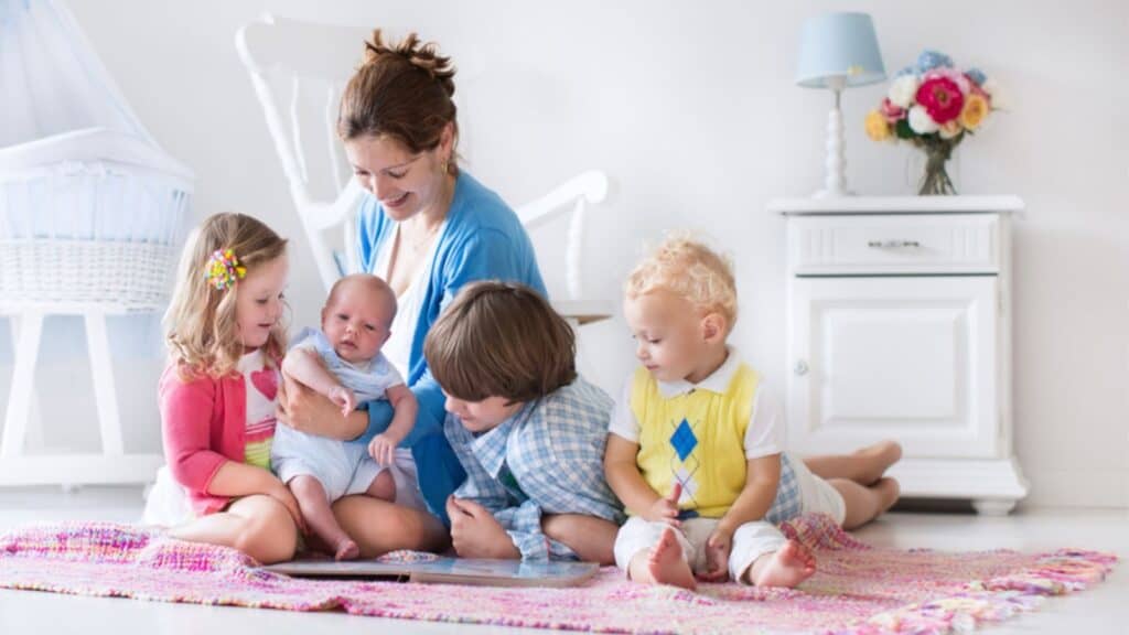Mother and kids playing in bedroom