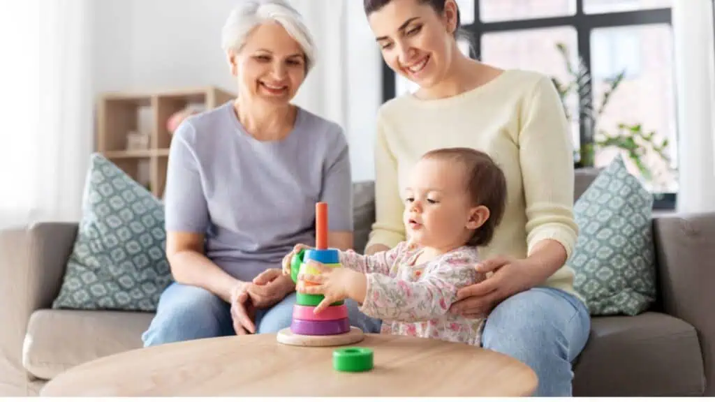 Mother, baby daughter and grandmother playing at home