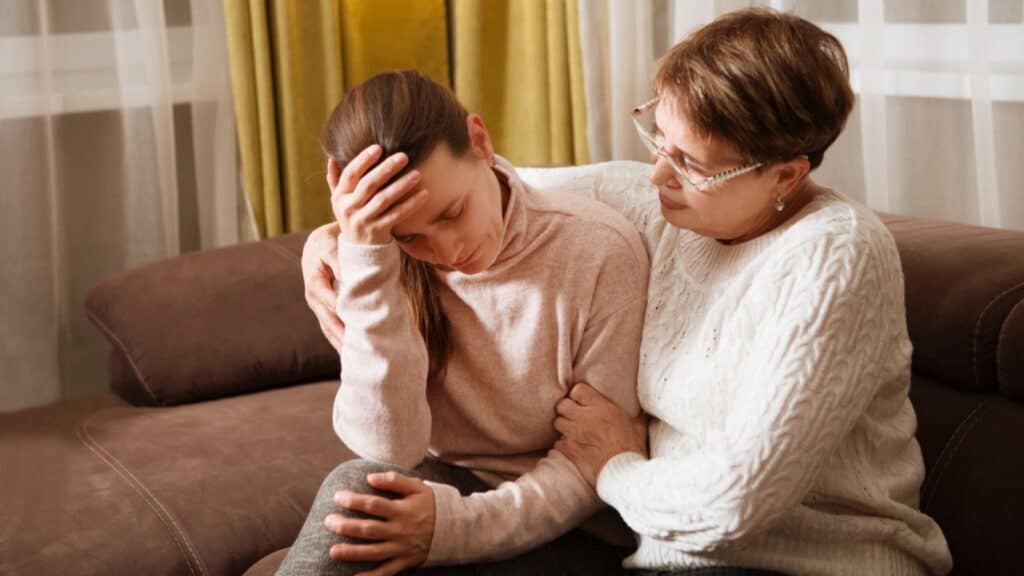 Mother saying sorry to her adult daughter