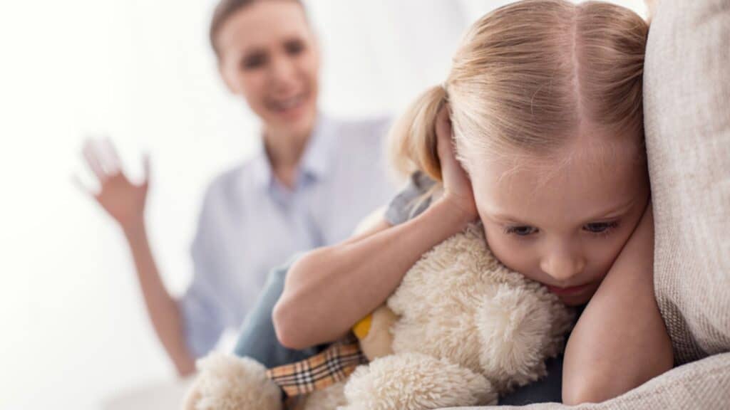 Mother yelling her daughter covering ears