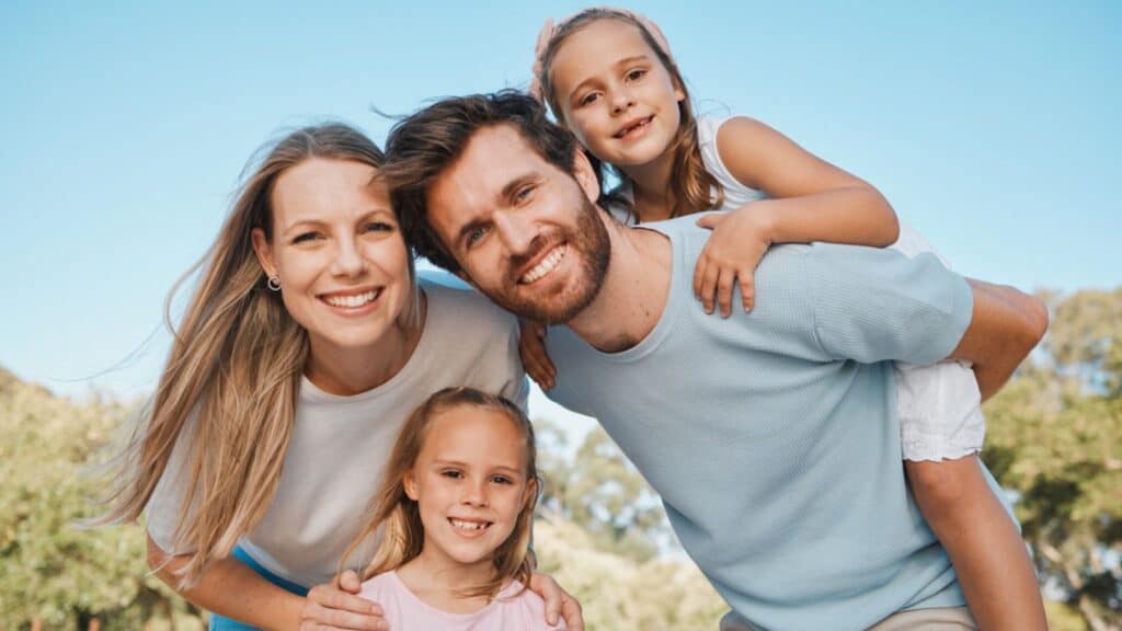 Nature portrait, smile and family children, mother and father enjoy time together