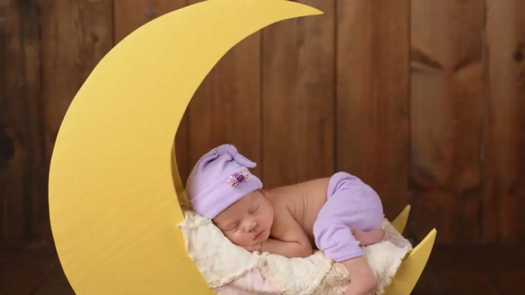 Newborn Girl Sleeping on the Moon