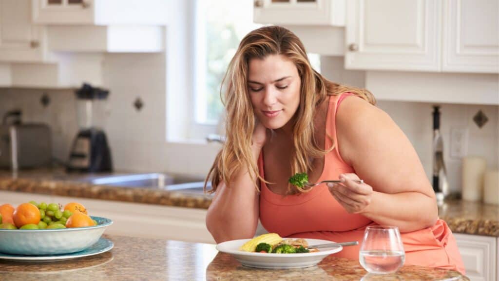 Overweight woman eating diet foods