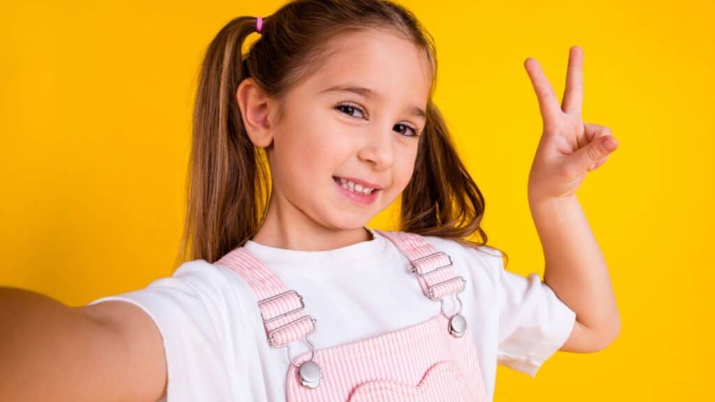 Photo of cute charming preschool girl dressed pink clothes