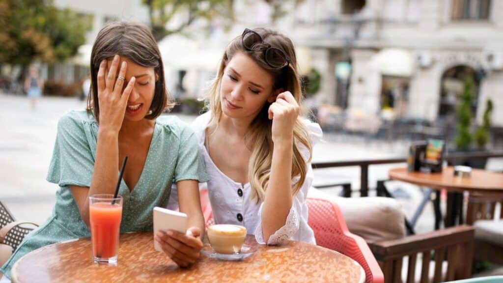 Sad woman getting support from her best friend outdoor