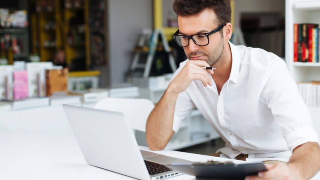 Serious man working on laptop