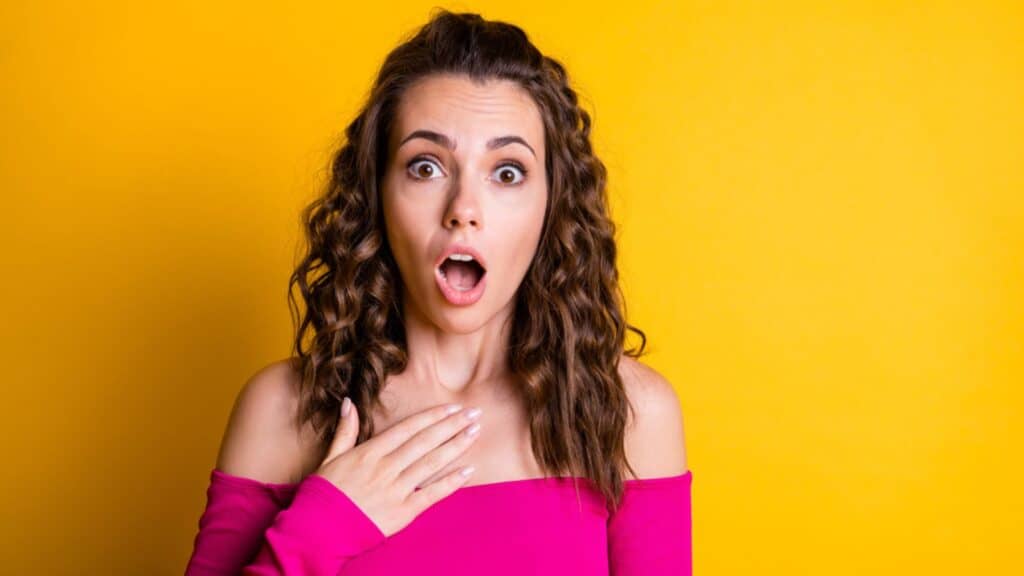 Shocked woman wearing pink crop-top