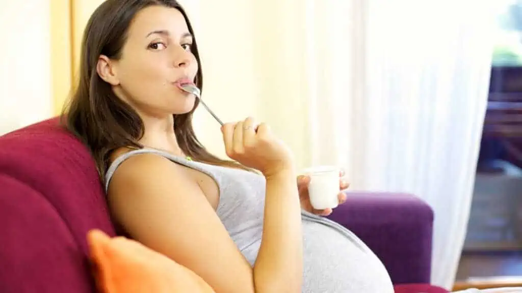 pregnant woman eating yogurt