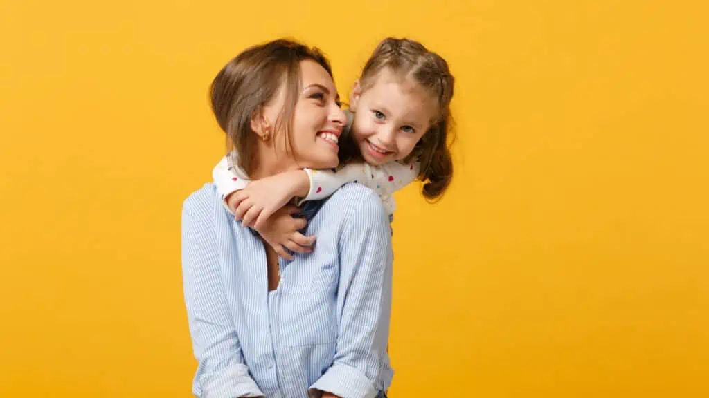 mom and daughter smiling