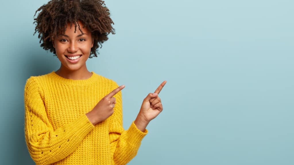 happy woman pointing in yellow