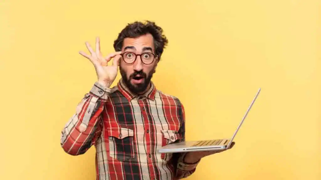 shocked man with computer and glasses