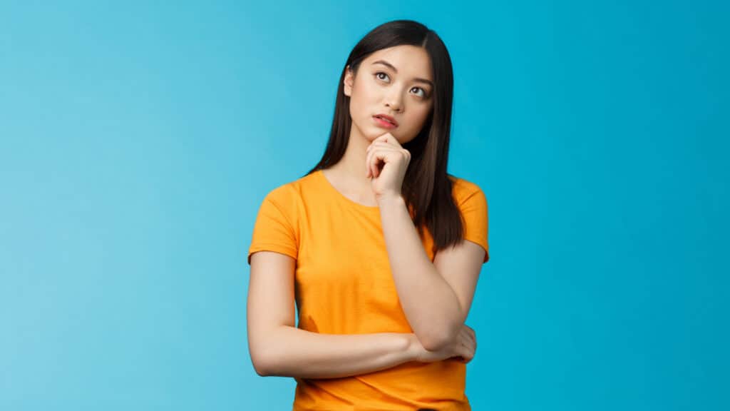 woman thinking blue background