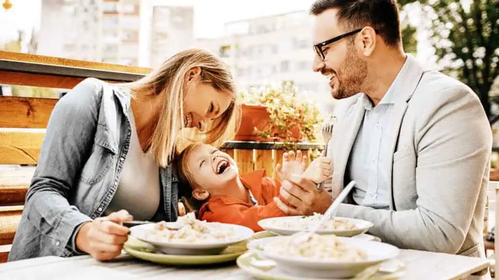 family laughing and enjoying a meal