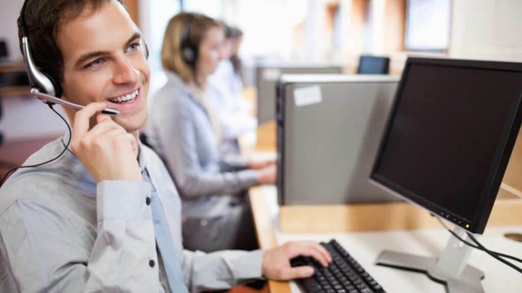 Smiling man customer assistant using a headset