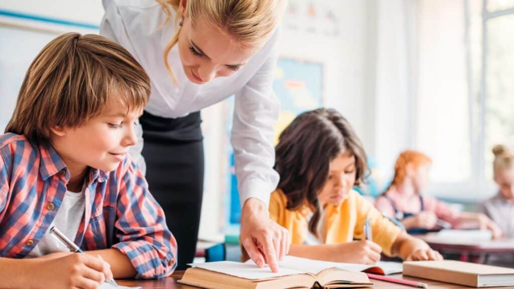 Teacher helping the kids at the school