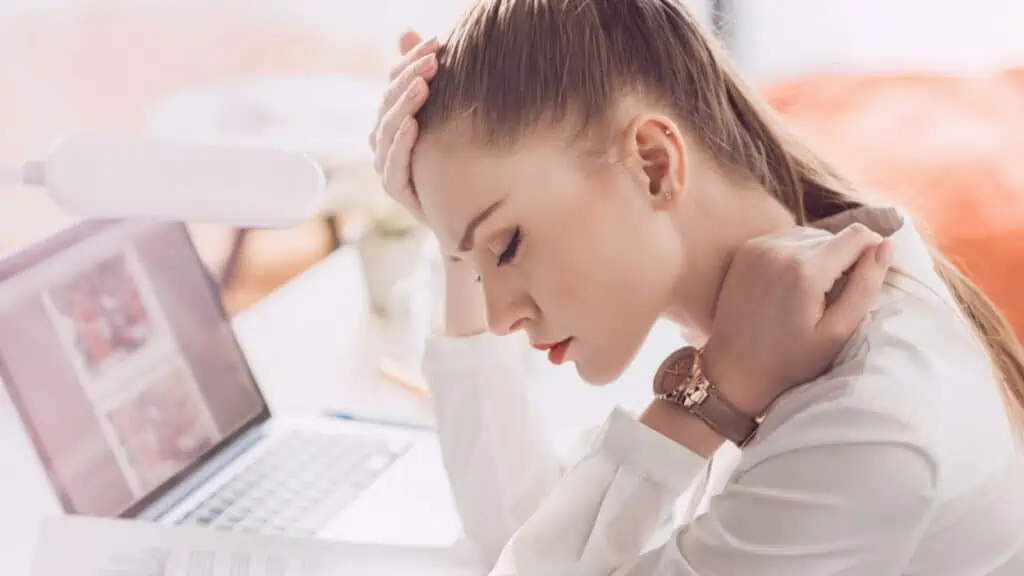 Tired businesswoman with laptop